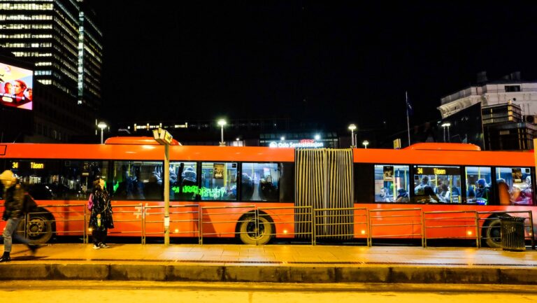 orange and white bus on road during night time